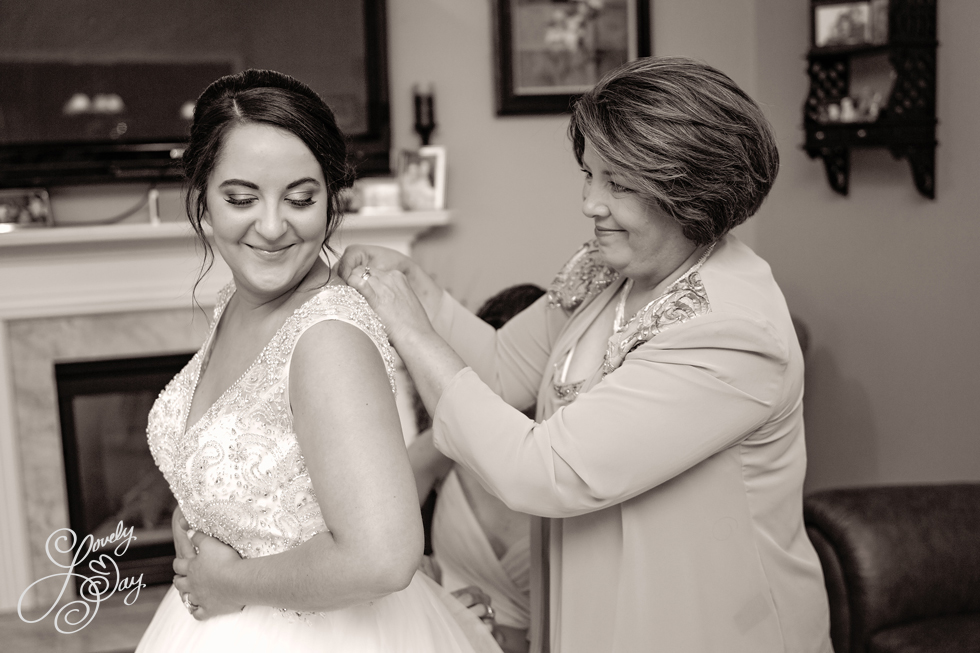 Mom helping bride get ready on her wedding day